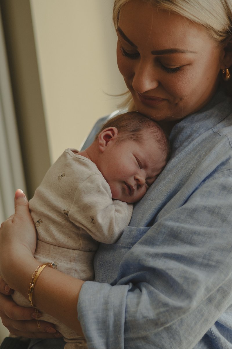 Mum embracing baby born through Essential Fertility Treatment